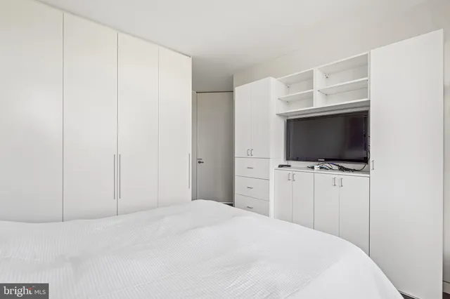 a bedroom with a bed and a flat screen tv