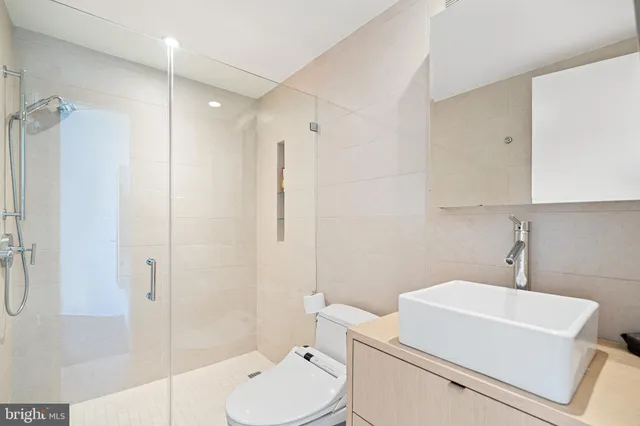 a bathroom with a toilet a sink and shower