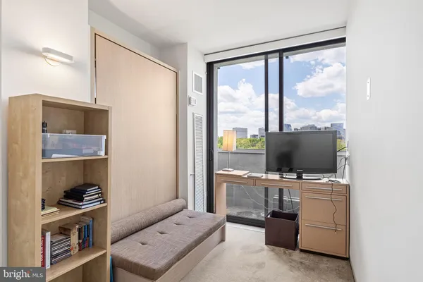 a view of workspace with flat screen tv and fan