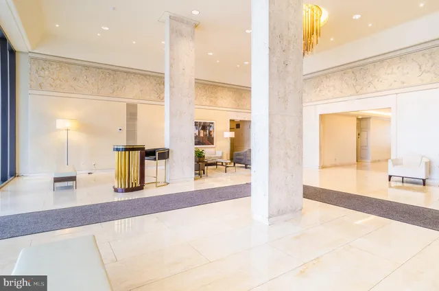 a living room with couches a coffee table and next to a window with outer view