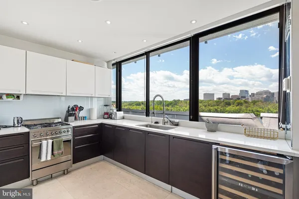 a kitchen with a sink a stove and cabinets