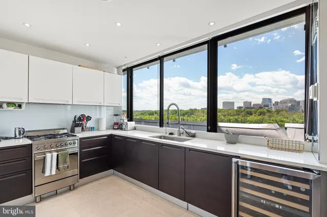 a kitchen with a sink a stove and cabinets