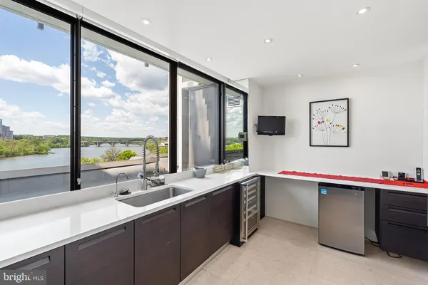 a kitchen with sink and large window
