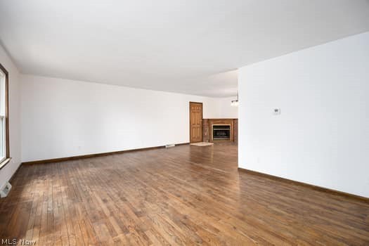 4293 Good Road Seville, OH 44273 - Photo 20 of 35 Unfurnished living room with a fireplace and dark wood-type flooring