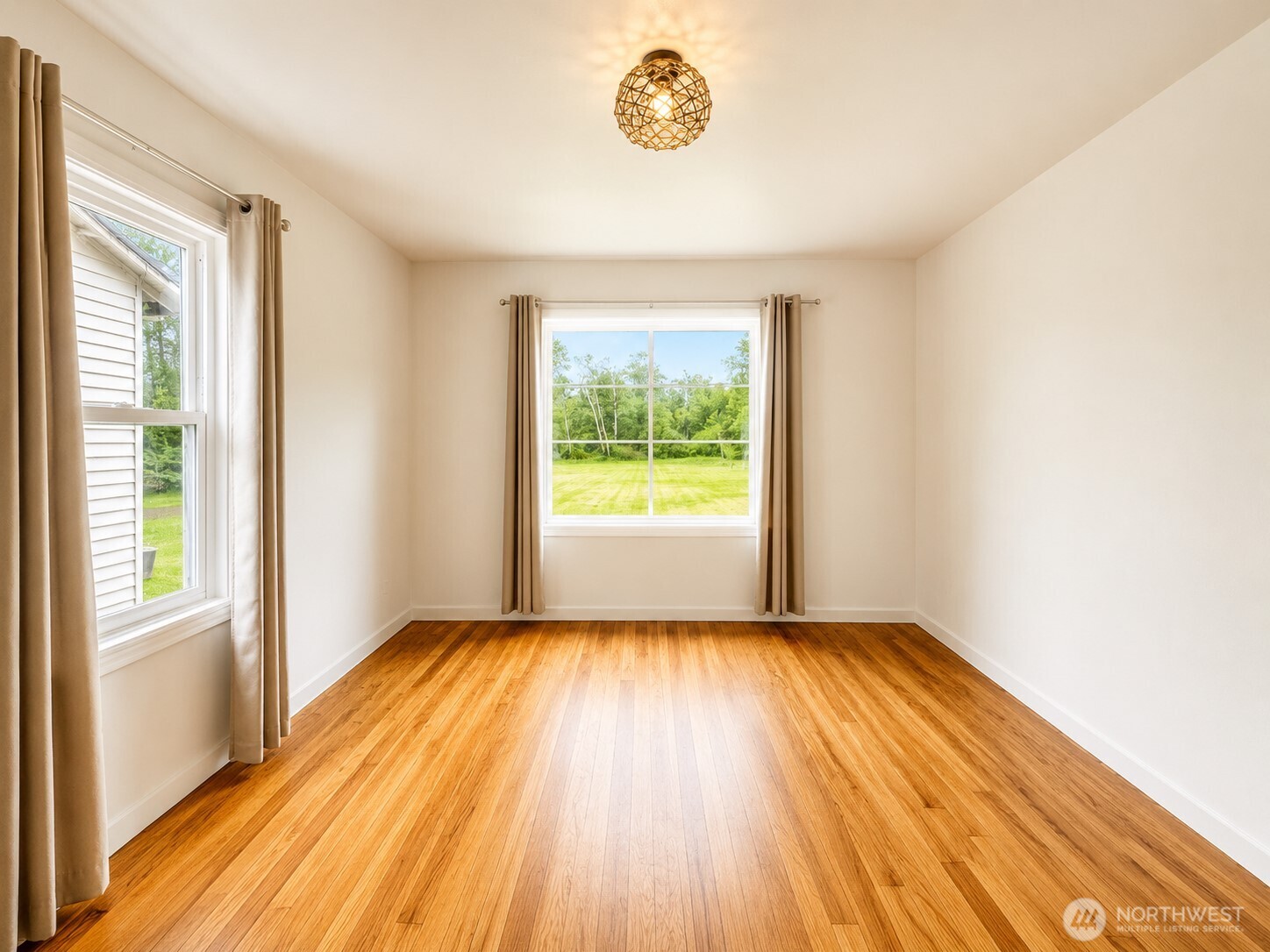 2154 Cranberry Road Grayland, WA 98547 - Photo 16 of 38 a view of an empty room with wooden floor and a window