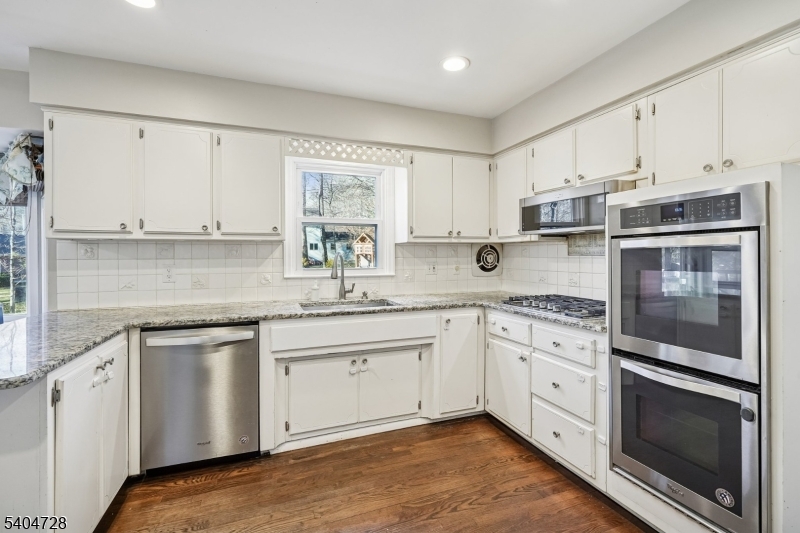 15 Southview Road Randolph, NJ 07869 - Photo 12 of 39 a kitchen with granite countertop white cabinets and white appliances