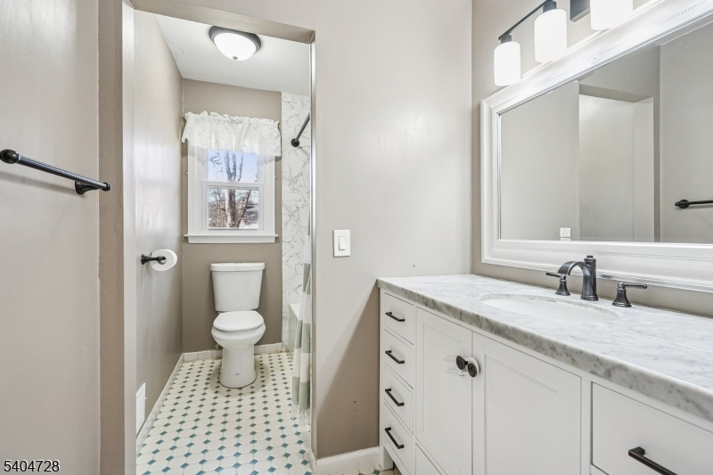 15 Southview Road Randolph, NJ 07869 - Photo 28 of 39 a bathroom with a granite countertop sink toilet a mirror and shower