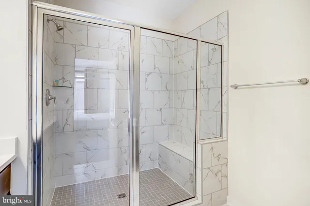 a bathroom with a glass shower door