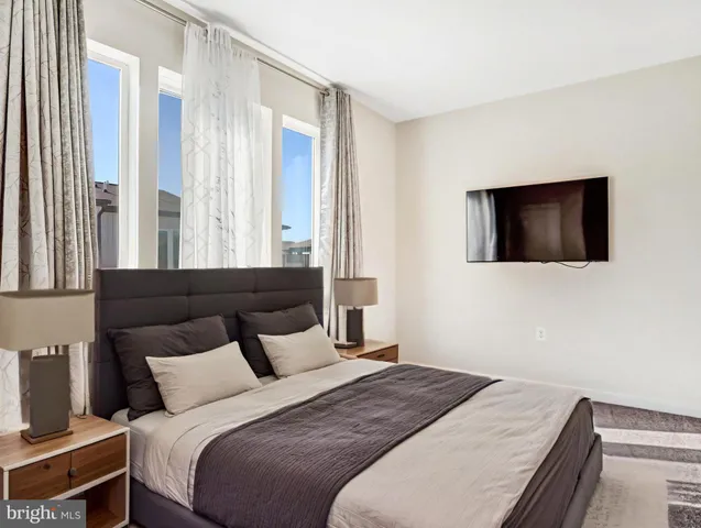 a bedroom with a bed and a flat screen tv