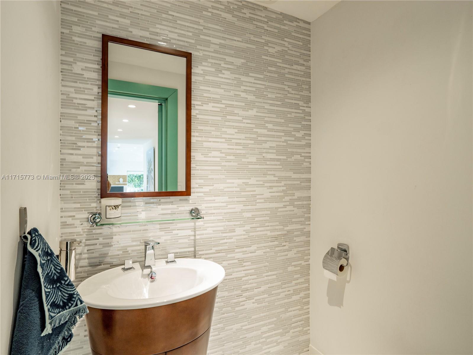 4365 North Bay Road Miami Beach, FL 33140 - Photo 12 of 35 a bathroom with a sink and a mirror