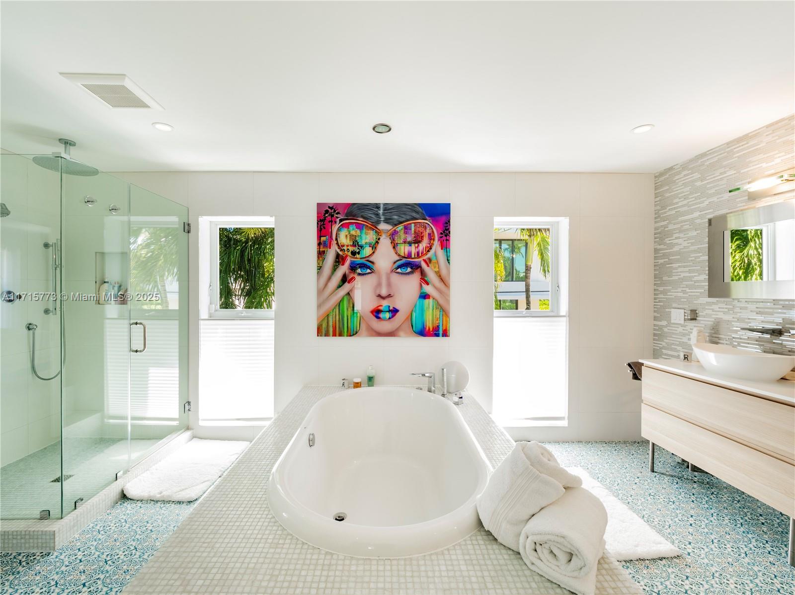 4365 North Bay Road Miami Beach, FL 33140 - Photo 18 of 35 a white tub sitting next to a bathroom sink