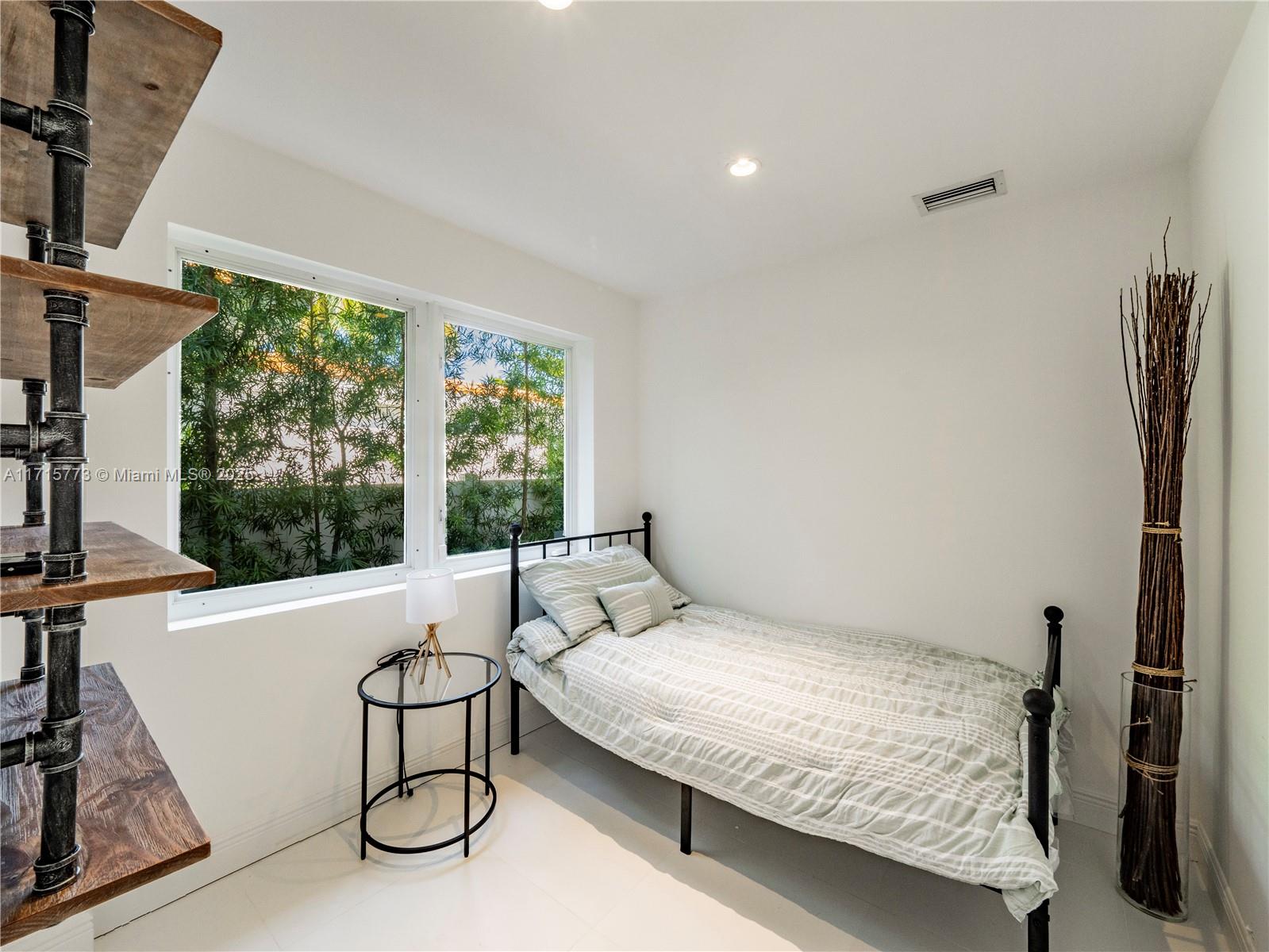 4365 North Bay Road Miami Beach, FL 33140 - Photo 24 of 35 a bedroom with a bed and a large window
