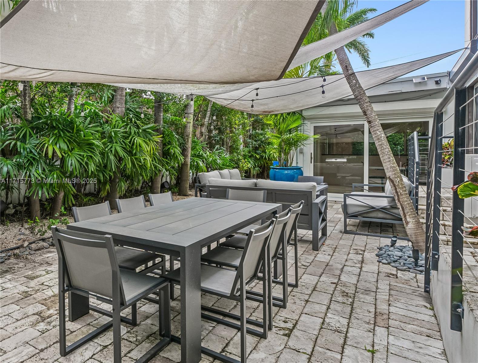 4365 North Bay Road Miami Beach, FL 33140 - Photo 27 of 35 a view of a patio with table and chairs and potted plants