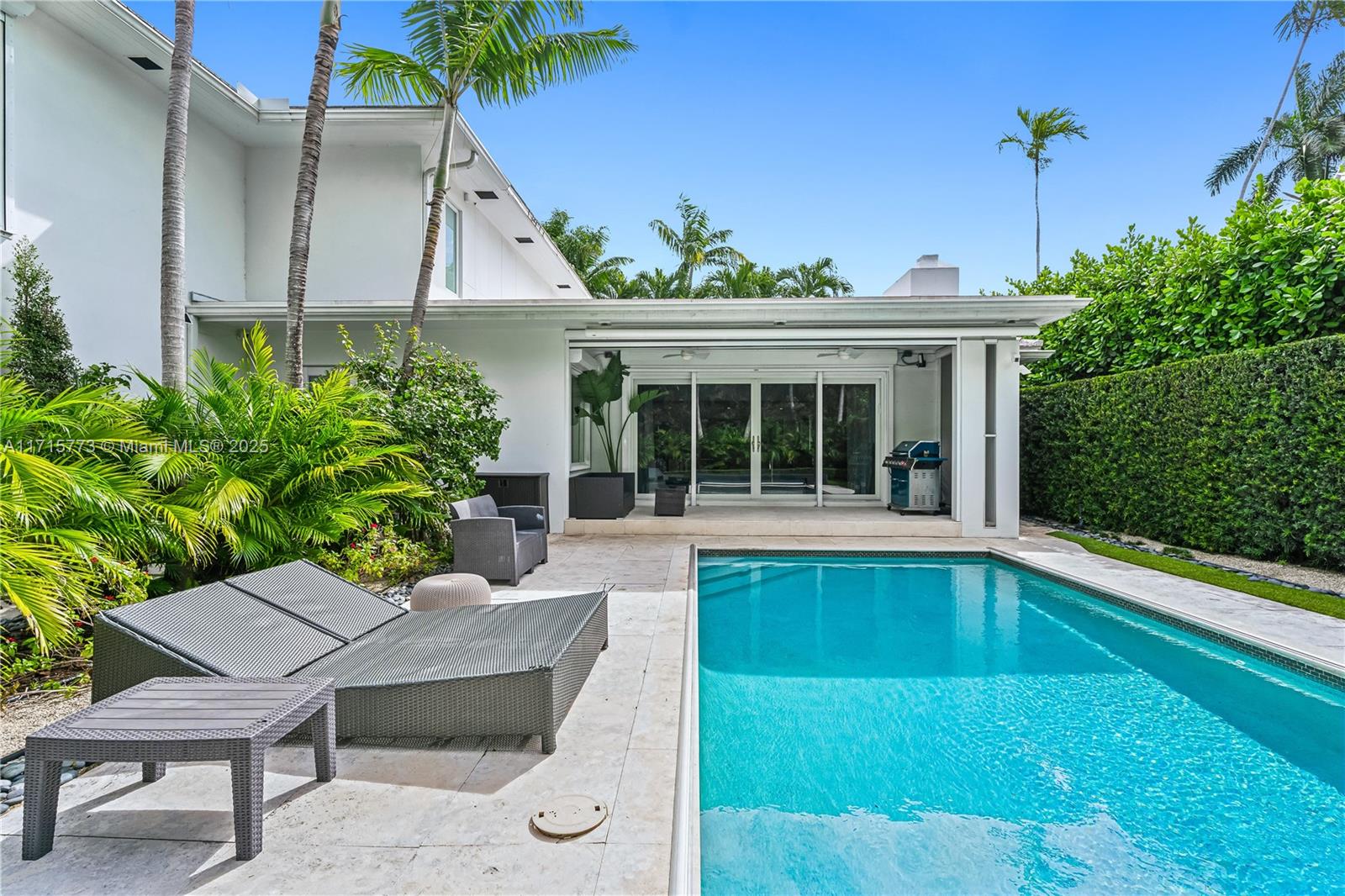 4365 North Bay Road Miami Beach, FL 33140 - Photo 29 of 35 a view of a house with backyard sitting area and garden