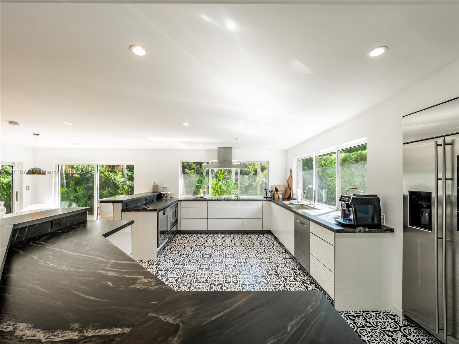 4365 North Bay Road Miami Beach, FL 33140 - Photo 3 of 35 a large white kitchen with a large window