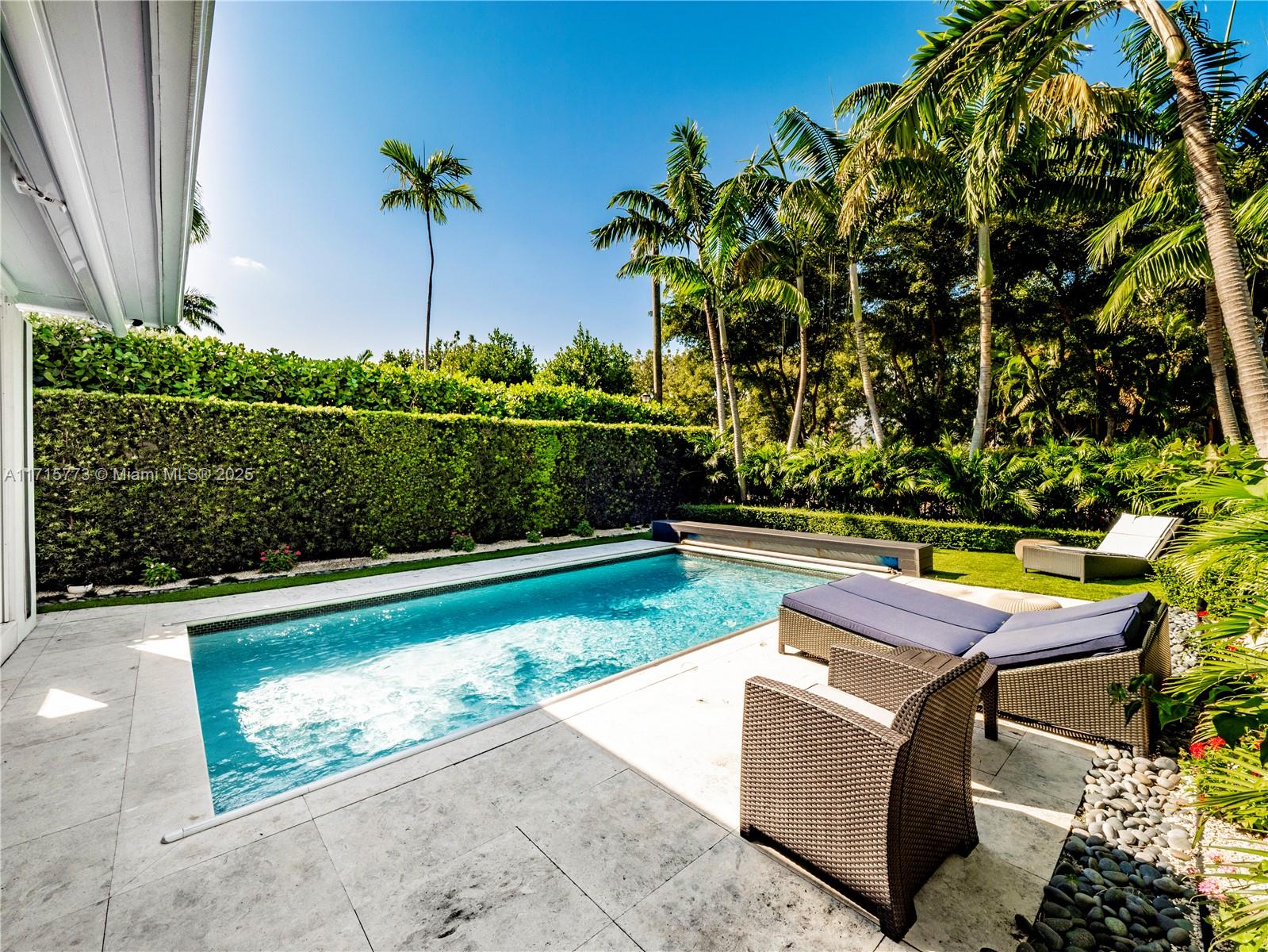 4365 North Bay Road Miami Beach, FL 33140 - Photo 31 of 35 a view of swimming pool with outdoor seating and plants