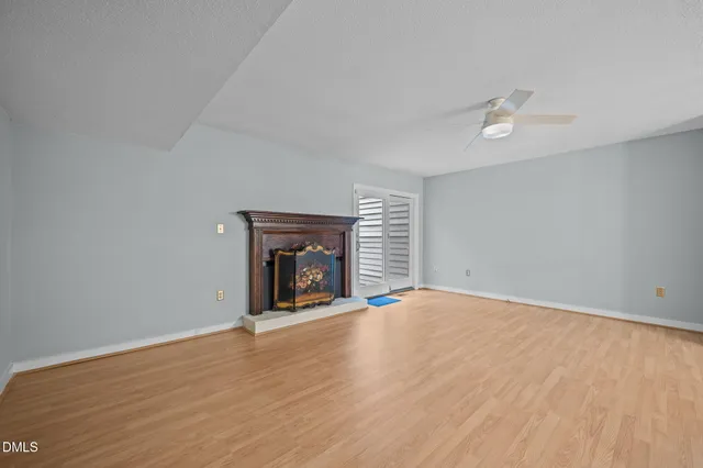 a view of a room with wooden floor and chandelier
