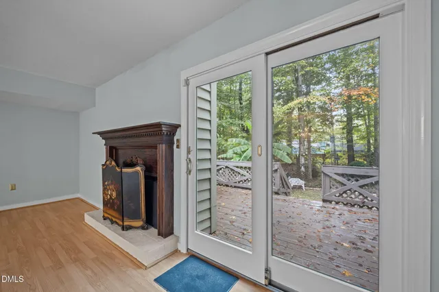 wooden floor in an empty room with a fireplace