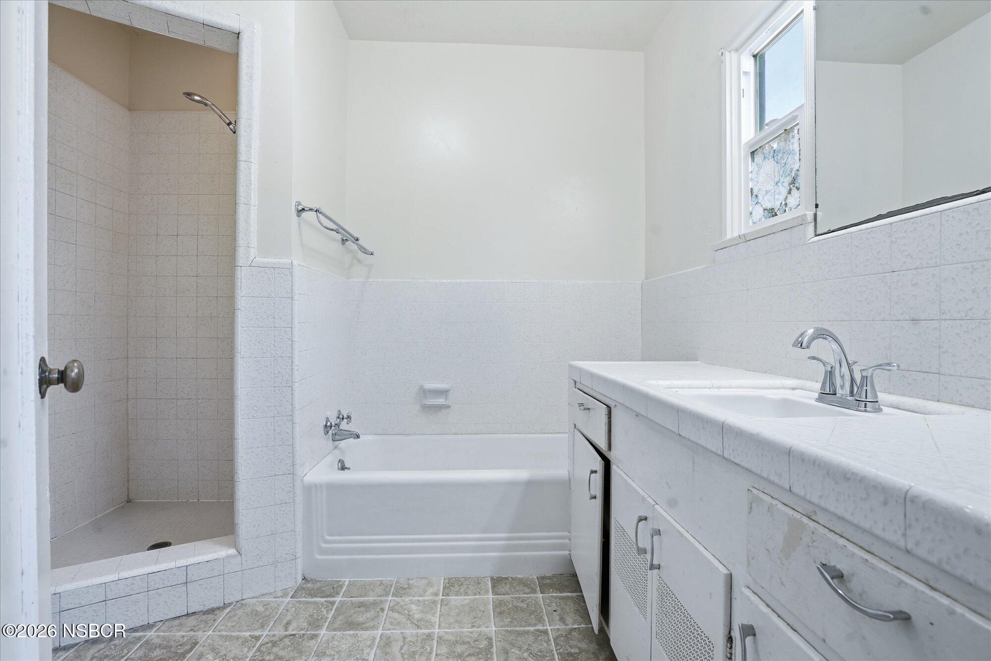 308 West Mill Street Santa Maria, CA 93458 - Photo 13 of 24 a bathroom with a bathtub and a sink
