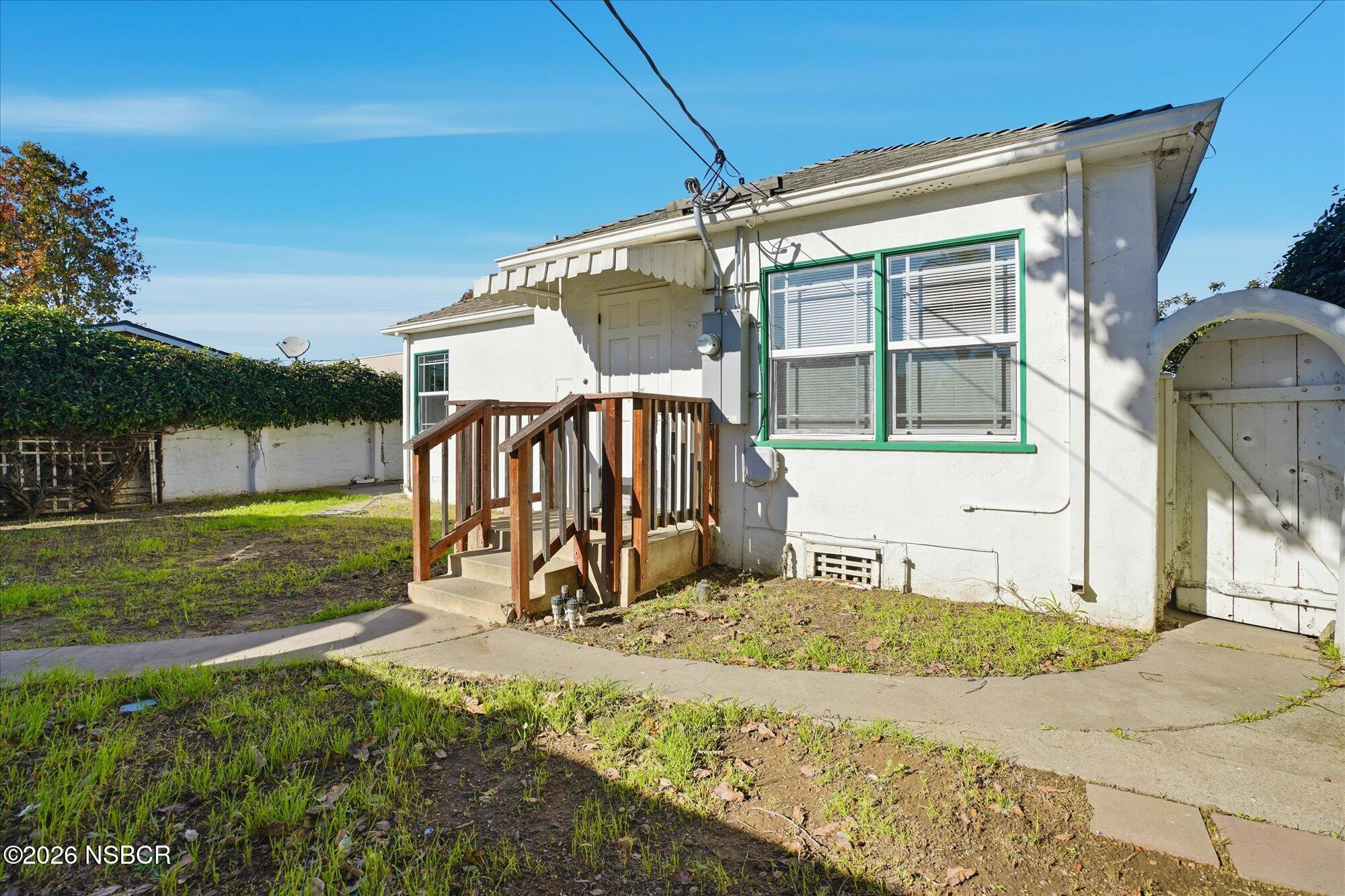 308 West Mill Street Santa Maria, CA 93458 - Photo 19 of 24 a view of a backyard with a garden and deck