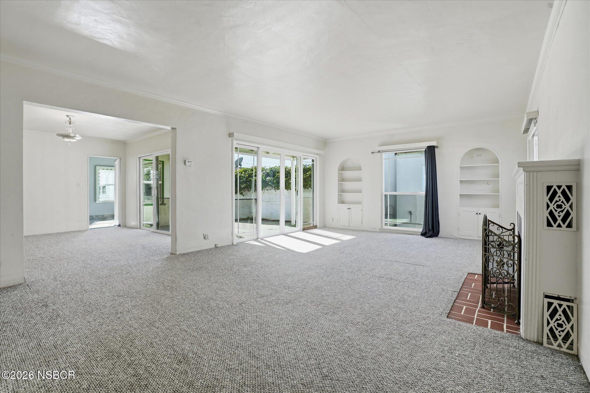 308 West Mill Street Santa Maria, CA 93458 - Photo 3 of 24 a view of a livingroom with wooden furniture and windows