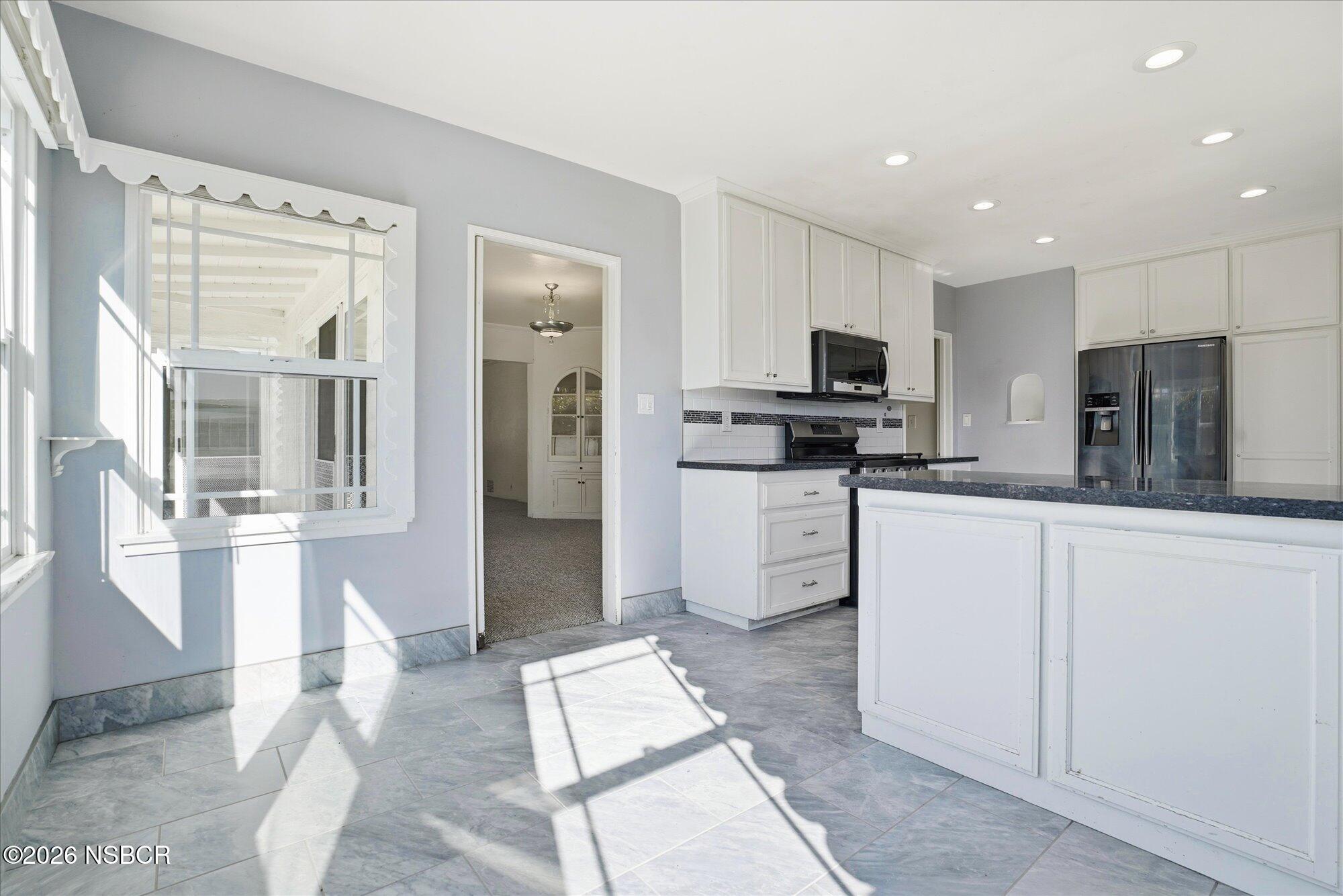 308 West Mill Street Santa Maria, CA 93458 - Photo 8 of 24 a kitchen with granite countertop a refrigerator oven a sink a counter top space and cabinets