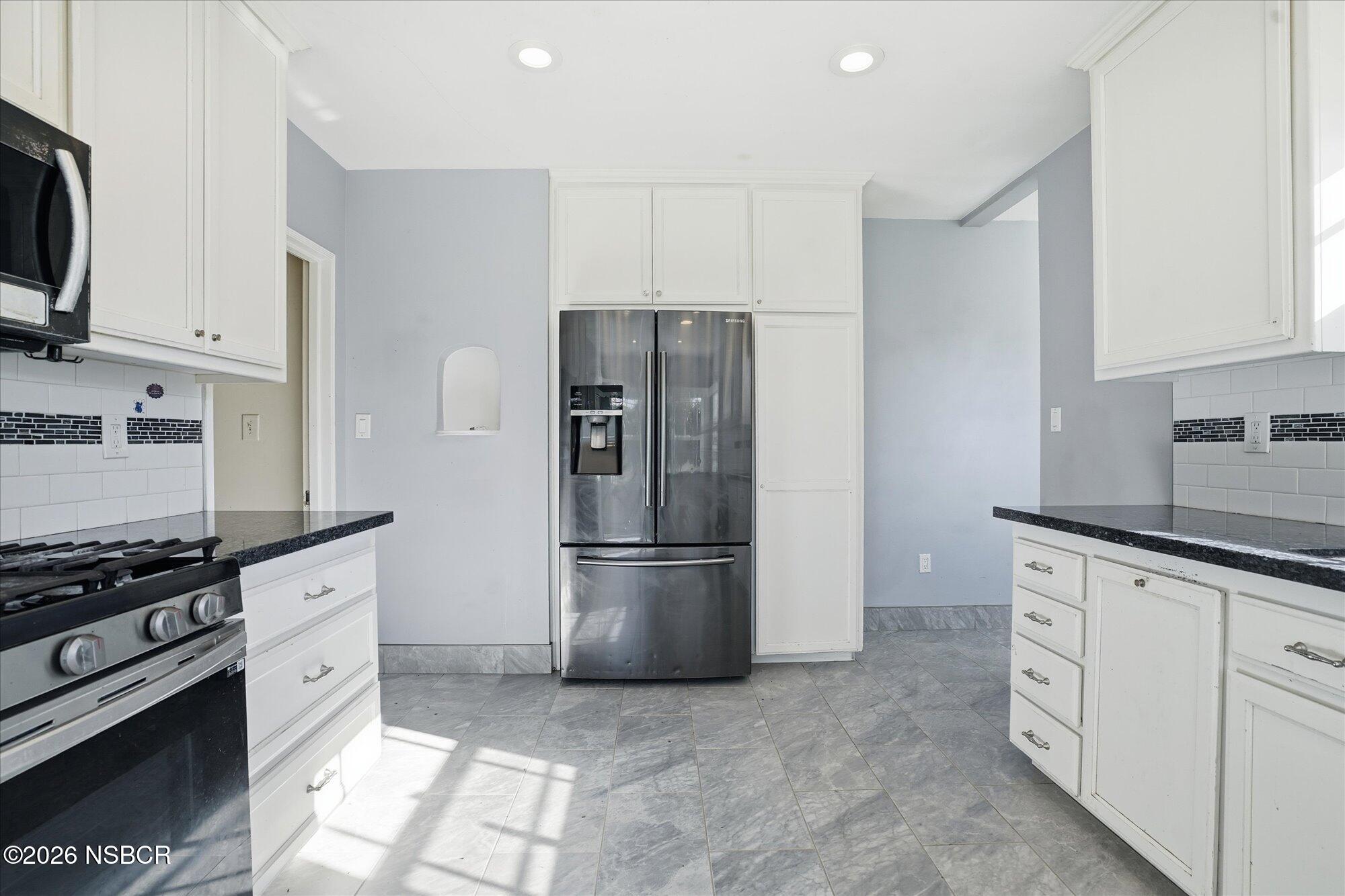 308 West Mill Street Santa Maria, CA 93458 - Photo 10 of 24 a kitchen with granite countertop a refrigerator stove and sink