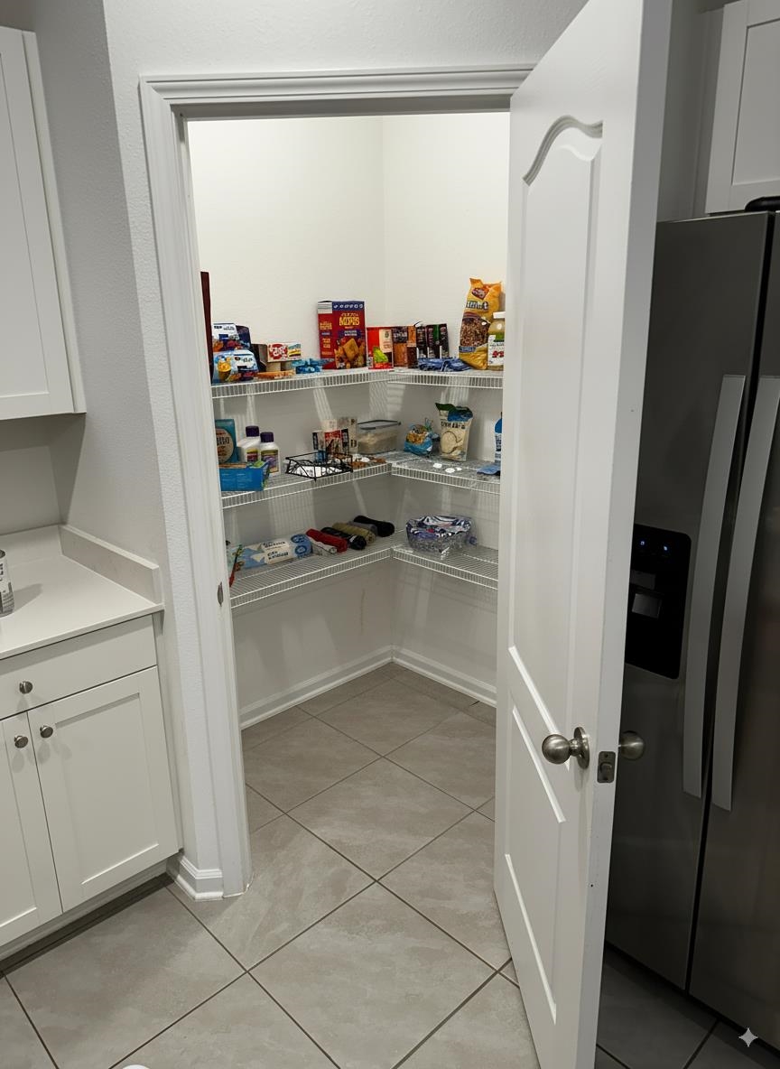 303 Redbud Road Palm Coast, FL 32137 - Photo 3 of 18 a view of storage and utility room with refrigerator and window