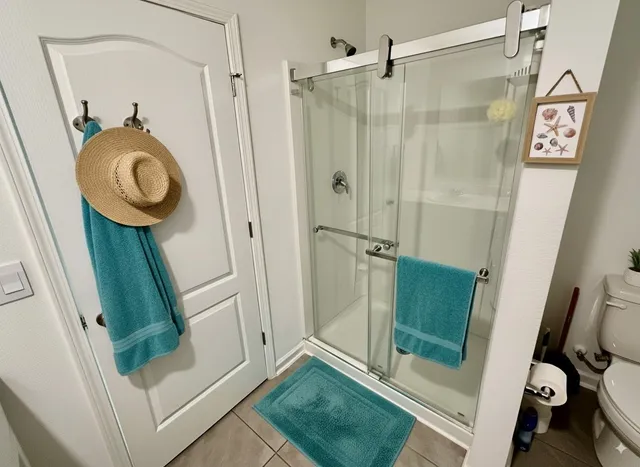 a view of bathroom with a shower and mirror