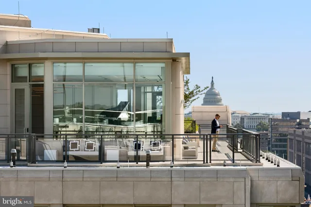 a building outdoor space with patio furniture and glass door