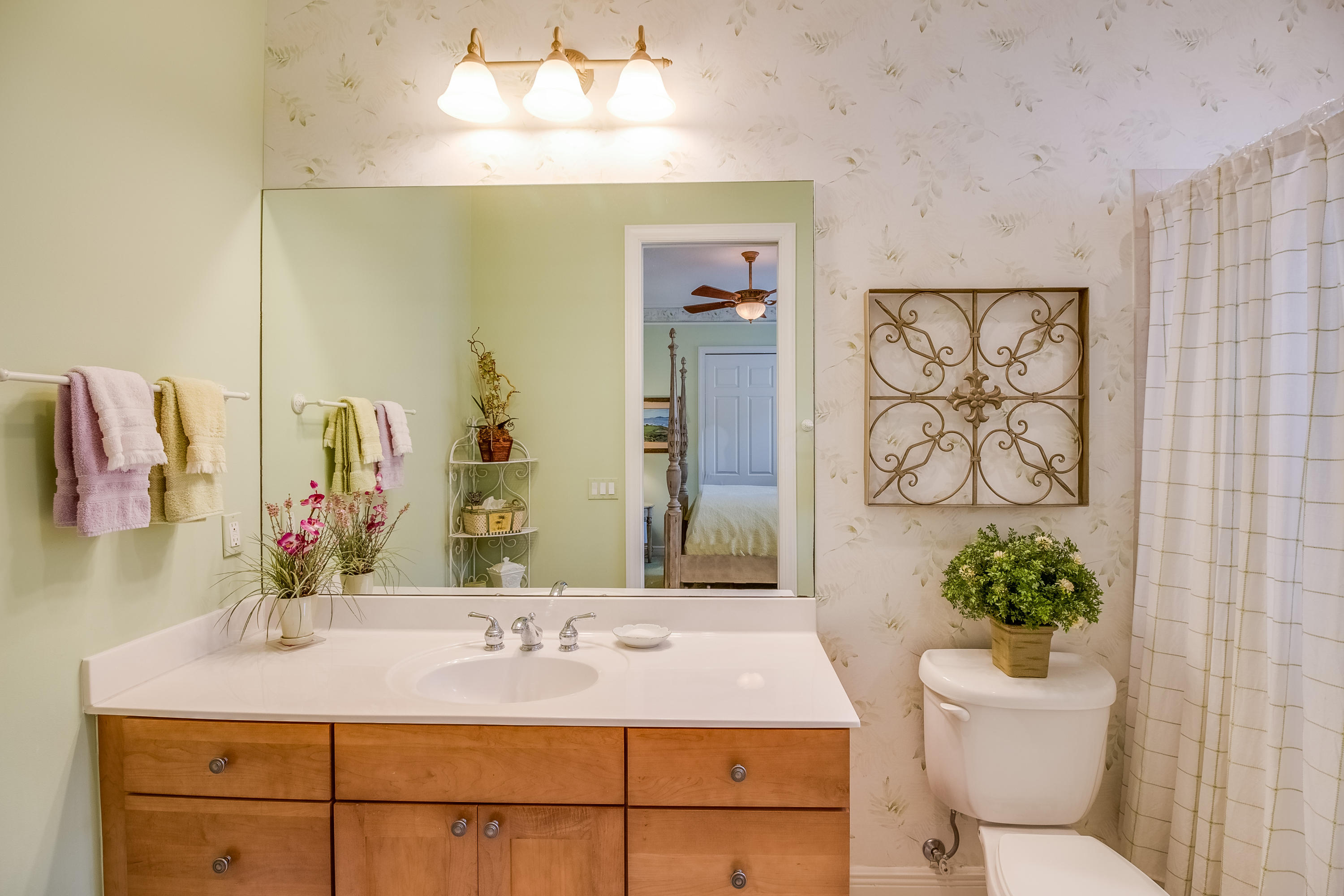 8617 Tompson Point Road Port St. Lucie, FL 34986 - Photo 27 of 38 a bathroom with a granite countertop sink a toilet and mirror