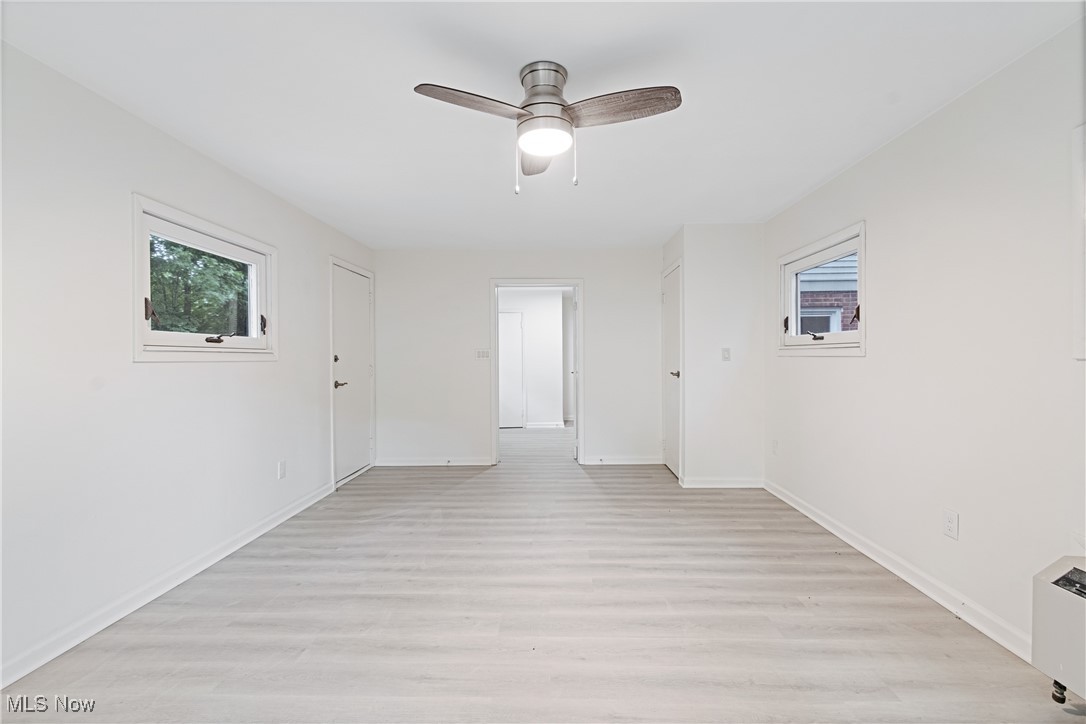 1057 Renfield Road Cleveland Heights, OH 44121 - Photo 15 of 30 Unfurnished room with light wood-type flooring, a wealth of natural light, and ceiling fan