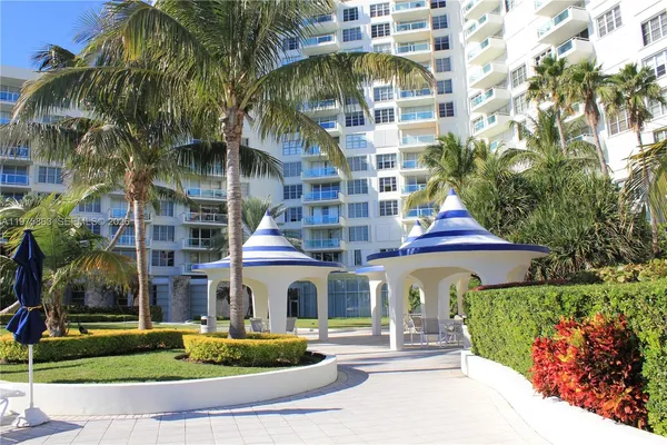 a front view of a multi story building with yard
