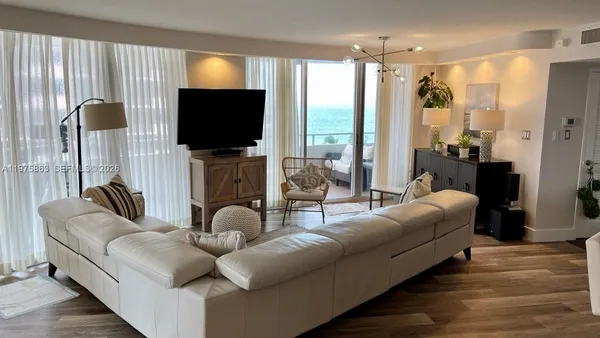 a living room with fireplace furniture and a flat screen tv
