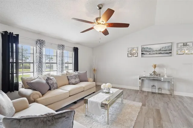 a living room with furniture and a large window