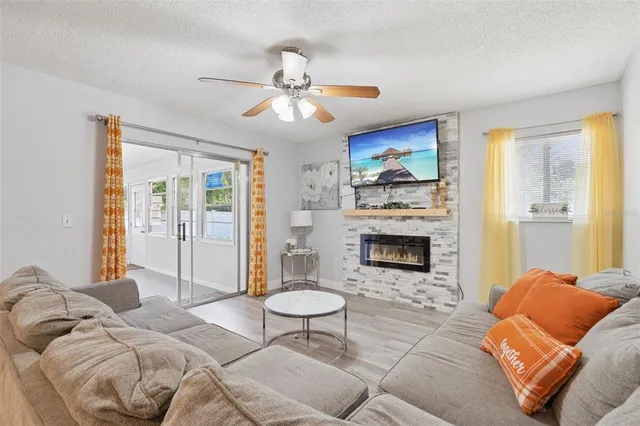 a living room with furniture a fireplace and a flat screen tv