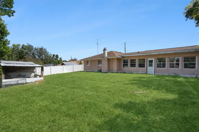 a view of a house with a backyard