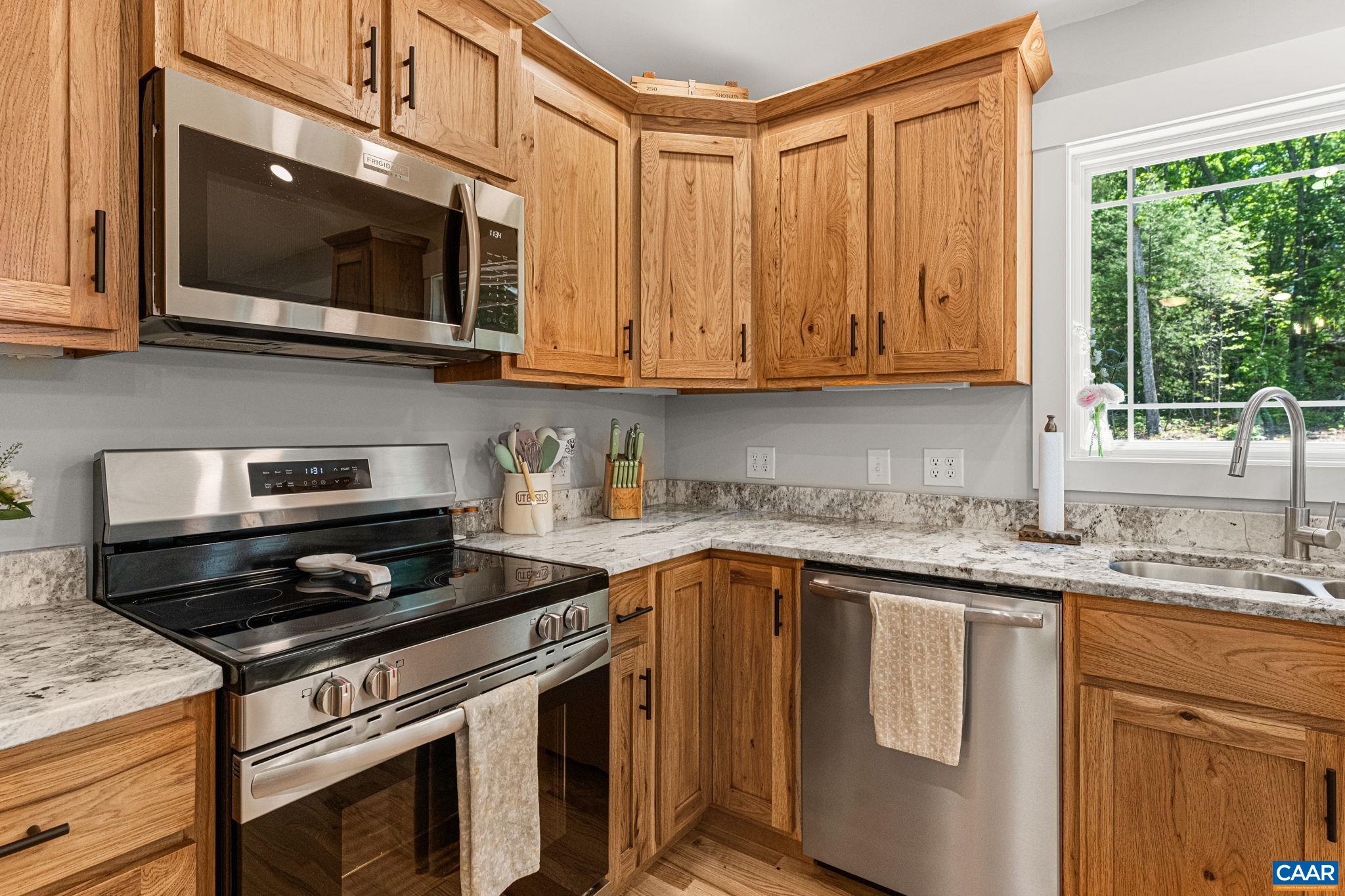 230 Fox Hollow Road Ruckersville, VA 22968 - Photo 12 of 42 a kitchen with stainless steel appliances granite countertop a sink stove and microwave