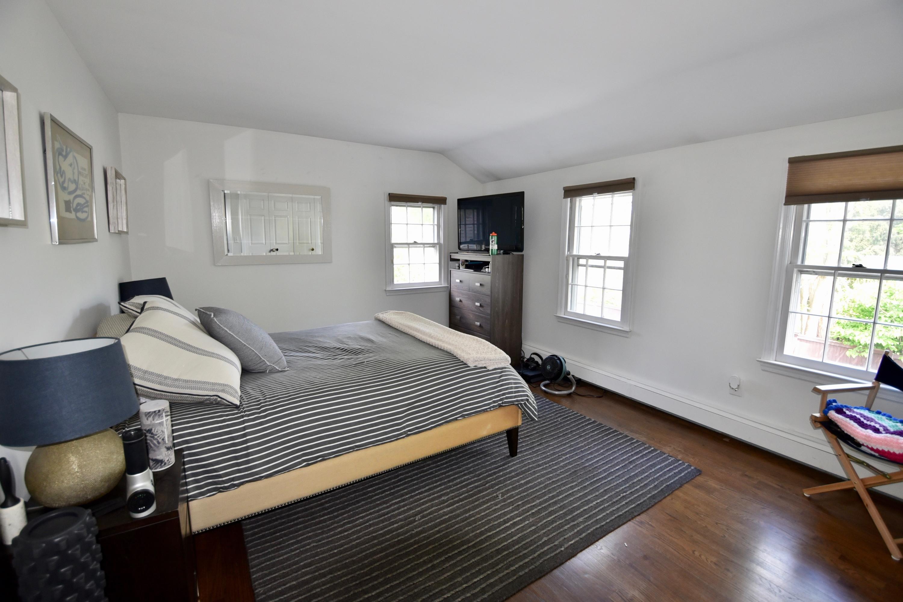 4 Hedge Row Darien, CT 06820 - Photo 11 of 15 a bedroom with a bed and wooden floor