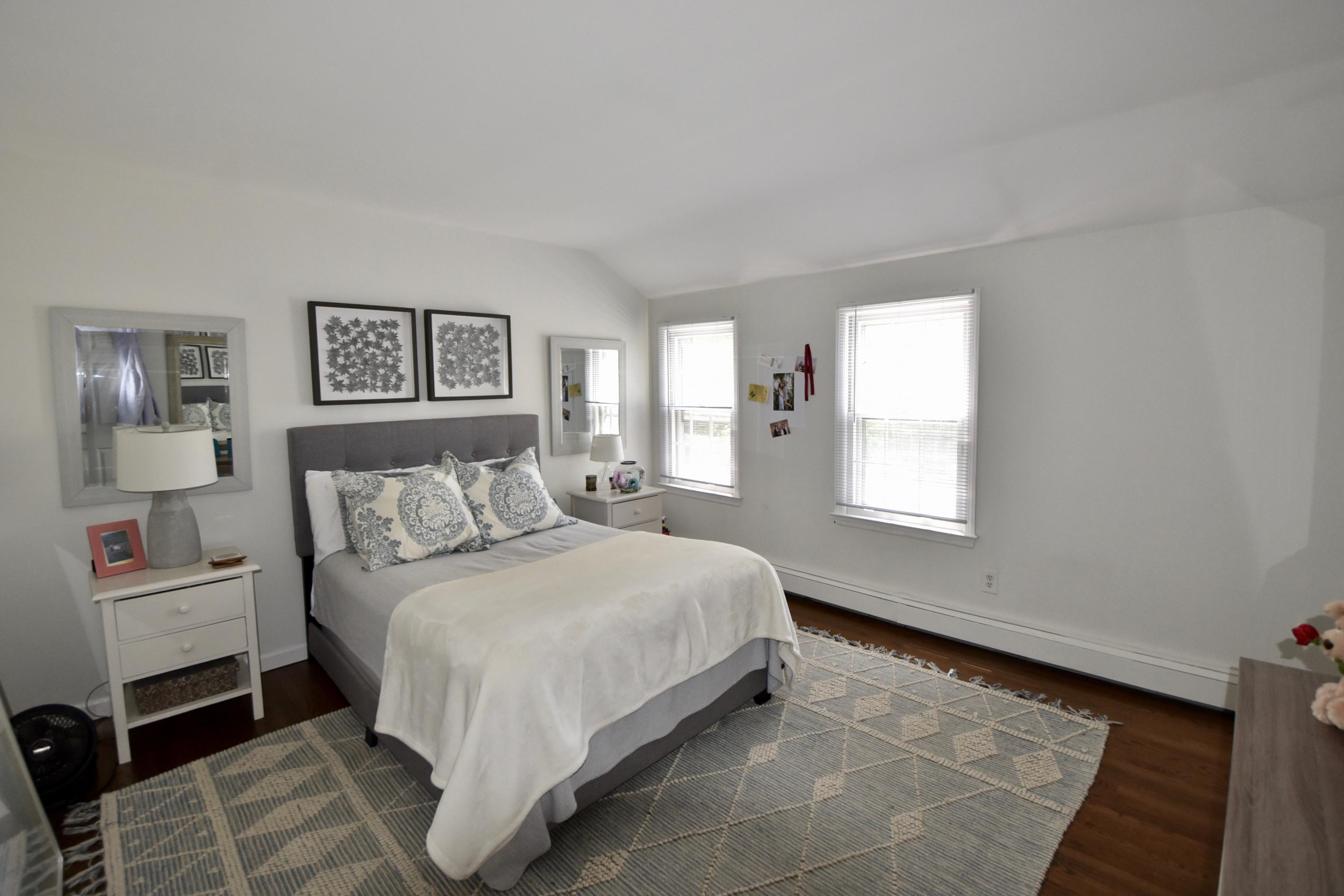 4 Hedge Row Darien, CT 06820 - Photo 9 of 15 a large bed sitting in a bedroom next to a window