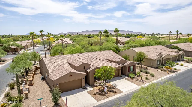 a front view of a house with a yard and potted plants