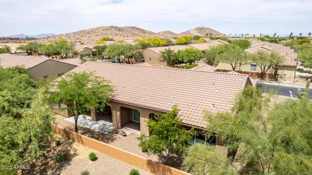 aerial view of a house with a yard and sitting area