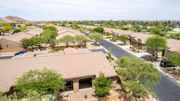 an aerial view of a multi story residential apartment building with a yard