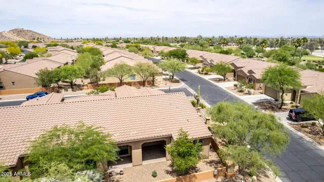 an aerial view of a multi story residential apartment building with a yard