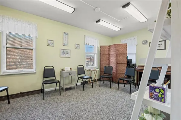 a living room with furniture a rug and a wooden floor