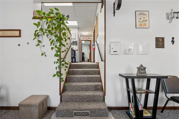 a view of a hallway with wooden floor and a potted plant