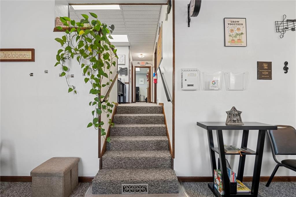 129 North Washington Street Butler, PA 16001 - Photo 5 of 42 a view of a hallway with wooden floor and a potted plant