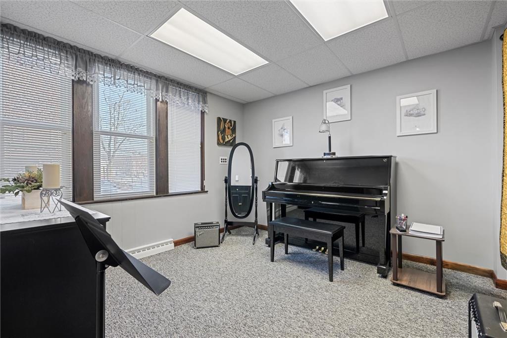 129 North Washington Street Butler, PA 16001 - Photo 9 of 42 a living room with furniture a piano and a window