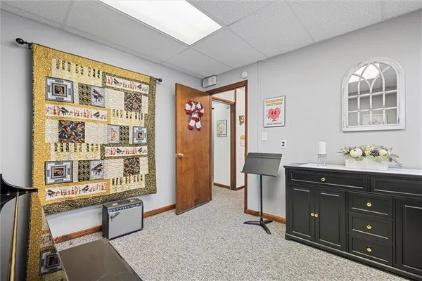 a view of a workspace with furniture and a window