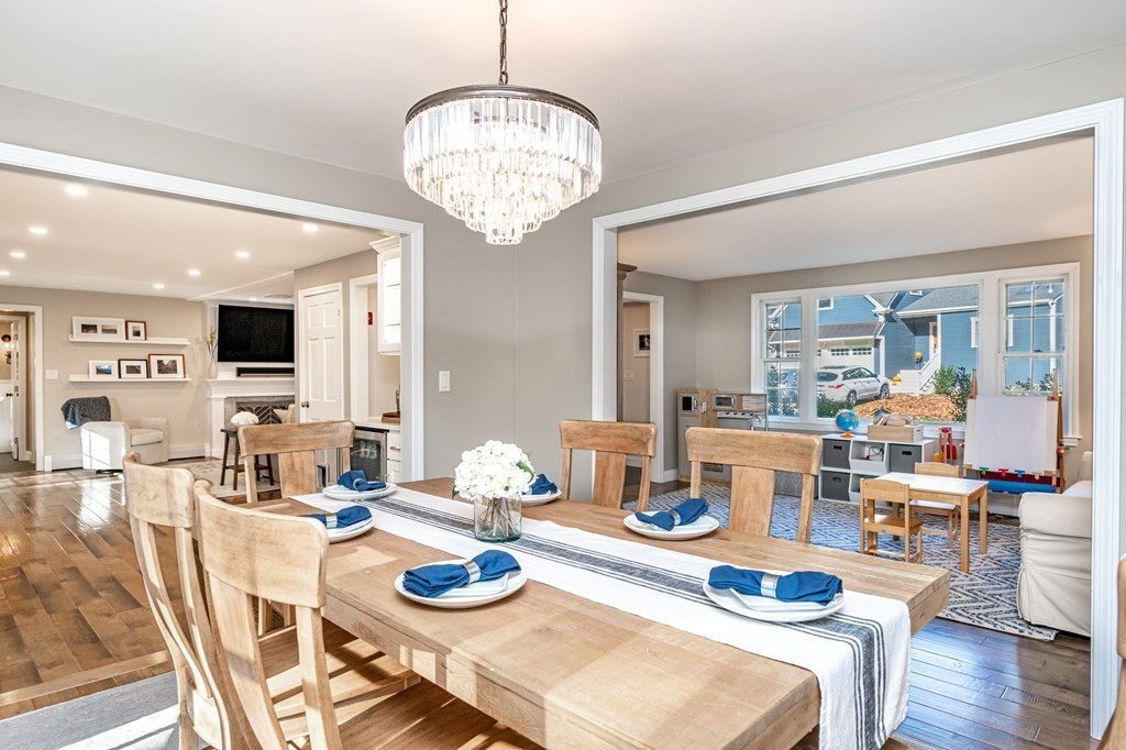 119 Gayland Road Needham, MA 02492 - Photo 16 of 42 a dining room with furniture a kitchen and chandelier